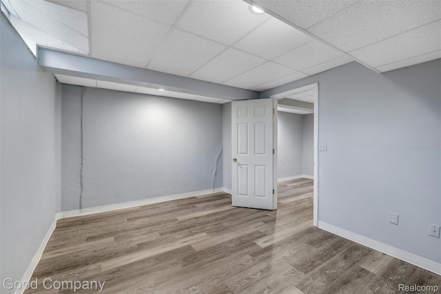 5893 Christina Dr, West Bloomfield, MI 48324 - finished basement featuring wood finished floors, a drop ceiling, and baseboards