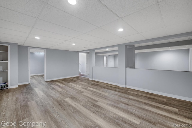5893 Christina Dr, West Bloomfield, MI 48324 - finished basement featuring wood finished floors, baseboards, and a paneled ceiling
