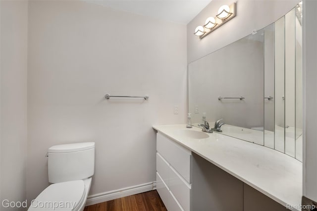 5893 Christina Dr, West Bloomfield, MI 48324 - bathroom featuring vanity, toilet, wood finished floors, and baseboards