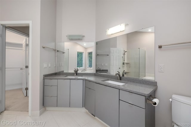 5893 Christina Dr, West Bloomfield, MI 48324 - bathroom featuring double vanity, a spacious closet, toilet, and a shower