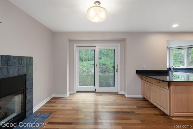 5893 Christina Dr, West Bloomfield, MI 48324 - dining room featuring a tile fireplace, wood finished floors, baseboards, and recessed lighting