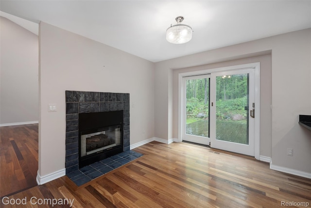 5893 Christina Dr, West Bloomfield, MI 48324 - unfurnished living room featuring wood finished floors, baseboards, and a tile fireplace