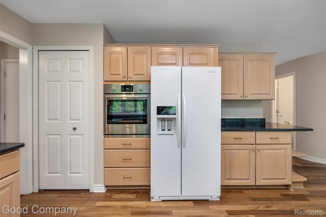 5893 Christina Dr, West Bloomfield, MI 48324 - kitchen featuring white refrigerator with ice dispenser, oven, light brown cabinets, light wood-style floors, and dark stone countertops