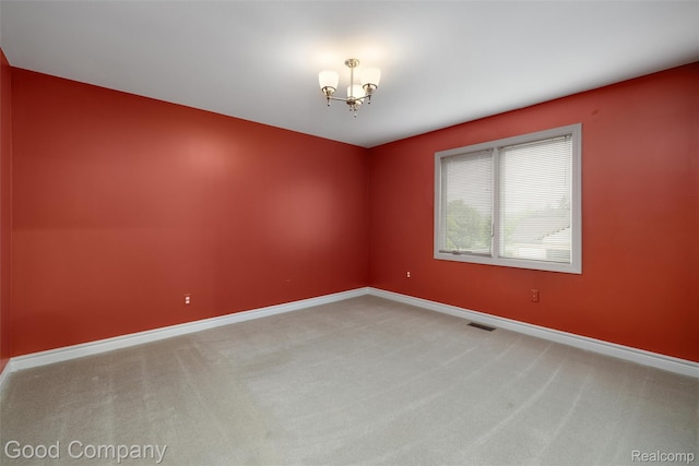 5893 Christina Dr, West Bloomfield, MI 48324 - spare room with carpet flooring, baseboards, and a chandelier