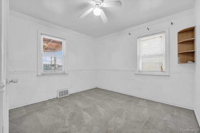 19165 Roger St, Melvindale, MI 48122 - empty room featuring a wainscoted wall, carpet floors, and ceiling fan