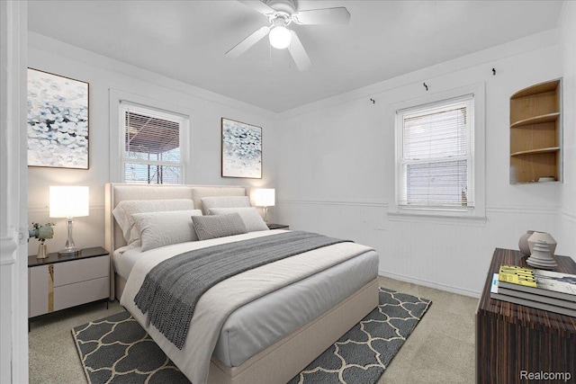 19165 Roger St, Melvindale, MI 48122 - bedroom with light colored carpet, multiple windows, ceiling fan, and wainscoting