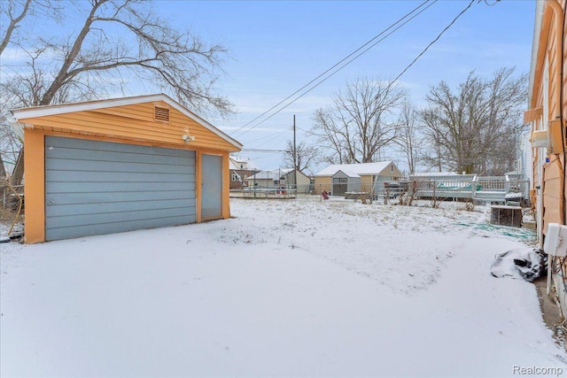19165 Roger St, Melvindale, MI 48122 - yard layered in snow with an outdoor structure and a detached garage