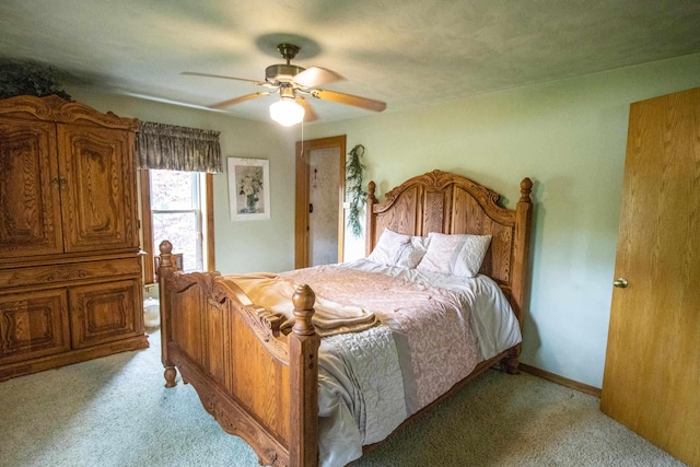 bedroom featuring light carpet and ceiling fan