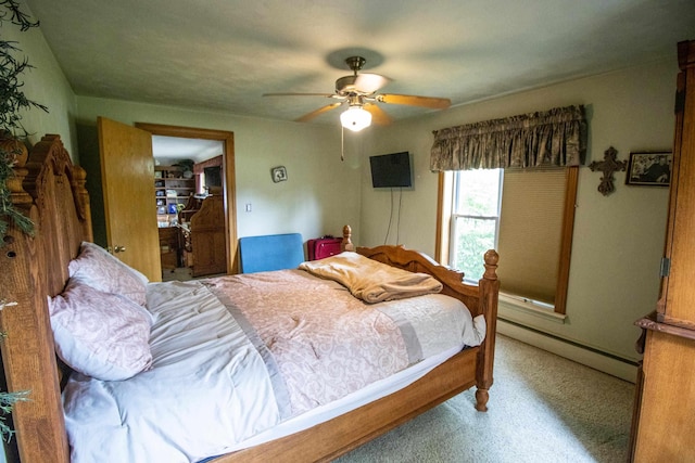 bedroom featuring baseboard heating, carpet floors, and a ceiling fan