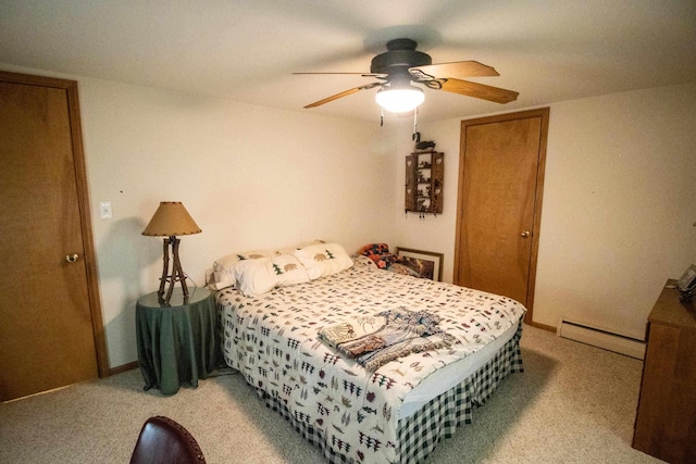 bedroom with a baseboard heating unit, light colored carpet, ceiling fan, a closet, and baseboards