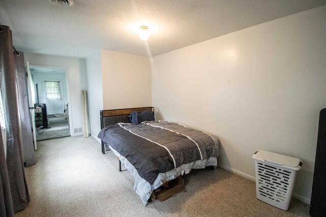 carpeted bedroom featuring baseboards