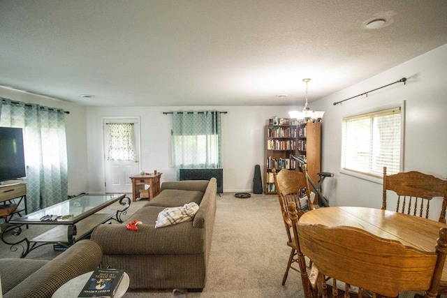 living room with a chandelier and light carpet