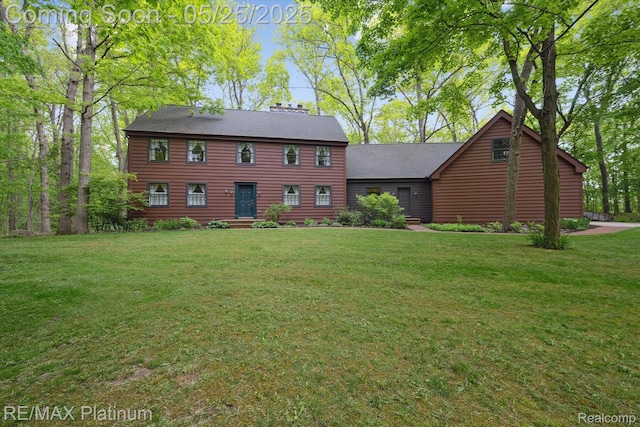 4121 Marsh Trl, Milford, MI 48380 - colonial-style house featuring a front lawn, a shingled roof, and a chimney