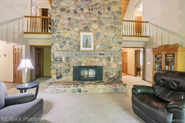 4121 Marsh Trl, Milford, MI 48380 - living area featuring a towering ceiling, carpet flooring, a stone fireplace, and baseboards