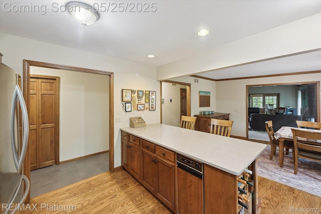 4121 Marsh Trl, Milford, MI 48380 - kitchen featuring freestanding refrigerator, a peninsula, light countertops, light wood finished floors, and recessed lighting