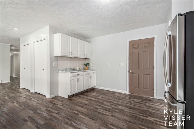 9020 5 Mile Rd NE, Ada, MI 49301 - kitchen featuring freestanding refrigerator, dark wood-style floors, white cabinetry, a textured ceiling, and baseboards