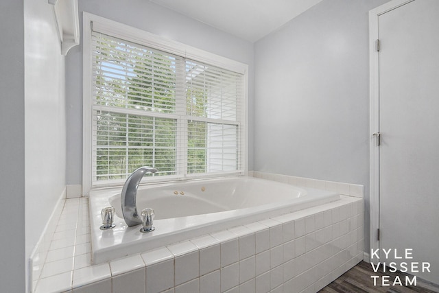 9020 5 Mile Rd NE, Ada, MI 49301 - full bath with healthy amount of natural light, a bath, and baseboards