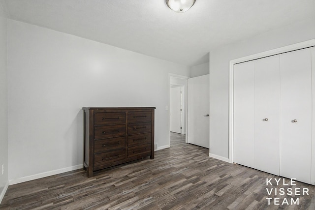 9020 5 Mile Rd NE, Ada, MI 49301 - unfurnished bedroom with wood finished floors, a closet, and baseboards