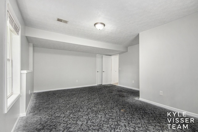 9020 5 Mile Rd NE, Ada, MI 49301 - finished basement featuring carpet, a textured ceiling, and baseboards