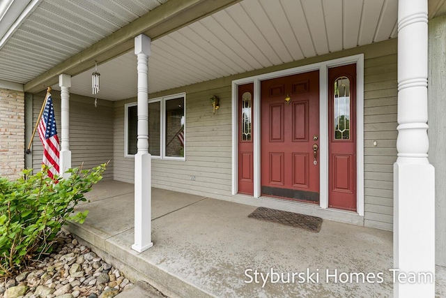 2490 Persimmon Pl NE, Belmont, MI 49306 - view of exterior entry with a porch