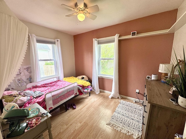 8251 Secor Rd, Lambertville, MI 48144 - bedroom with multiple windows, light wood finished floors, ceiling fan, and baseboards