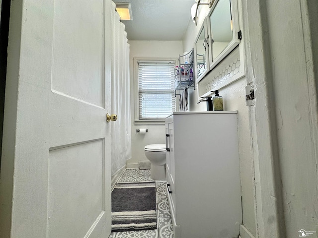 8251 Secor Rd, Lambertville, MI 48144 - bathroom with toilet, baseboards, and vanity