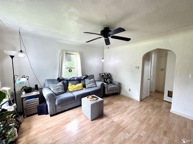 8251 Secor Rd, Lambertville, MI 48144 - living area featuring arched walkways, light wood-style floors, ceiling fan, a textured ceiling, and baseboards