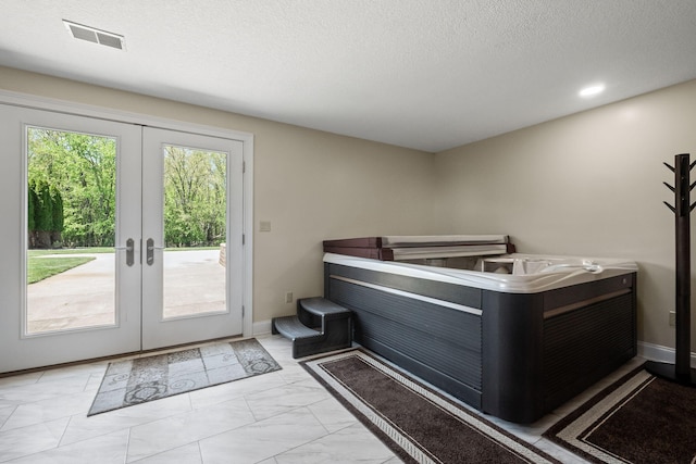 4624 Parman Rd, Stockbridge, MI 49285 - doorway with french doors, marble look tile flooring, a textured ceiling, and baseboards