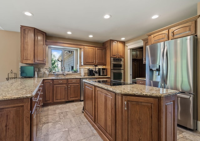 4624 Parman Rd, Stockbridge, MI 49285 - kitchen featuring stainless steel appliances, a sink, light stone countertops, a kitchen island, and stone tile floors