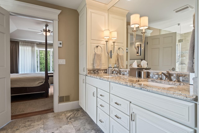 4624 Parman Rd, Stockbridge, MI 49285 - full bathroom featuring double vanity, ensuite bathroom, a ceiling fan, a shower stall, and baseboards