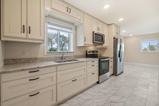 4624 Parman Rd, Stockbridge, MI 49285 - kitchen featuring appliances with stainless steel finishes, light marble finish floors, a sink, recessed lighting, and baseboards