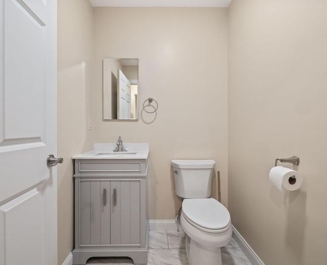 4624 Parman Rd, Stockbridge, MI 49285 - half bath featuring marble finish flooring, toilet, vanity, and baseboards