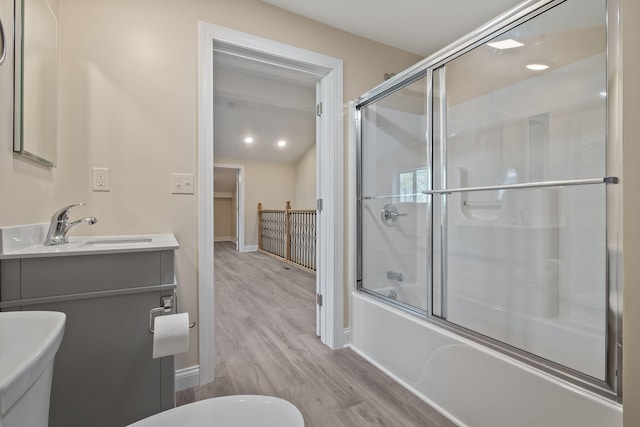 4624 Parman Rd, Stockbridge, MI 49285 - full bath with wood finished floors, combined bath / shower with glass door, lofted ceiling, vanity, and toilet