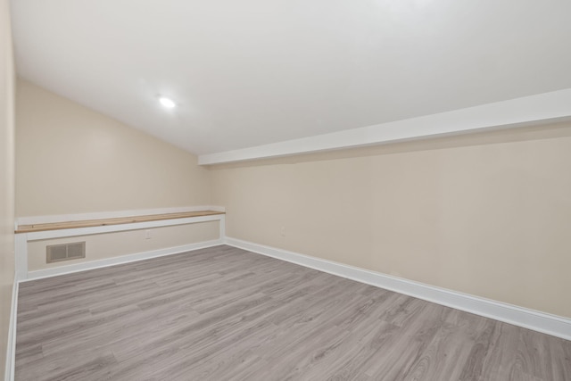 4624 Parman Rd, Stockbridge, MI 49285 - bonus room with lofted ceiling, light wood finished floors, baseboards, and recessed lighting