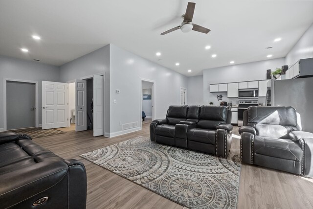 4624 Parman Rd, Stockbridge, MI 49285 - living area with ceiling fan, light wood finished floors, baseboards, and recessed lighting