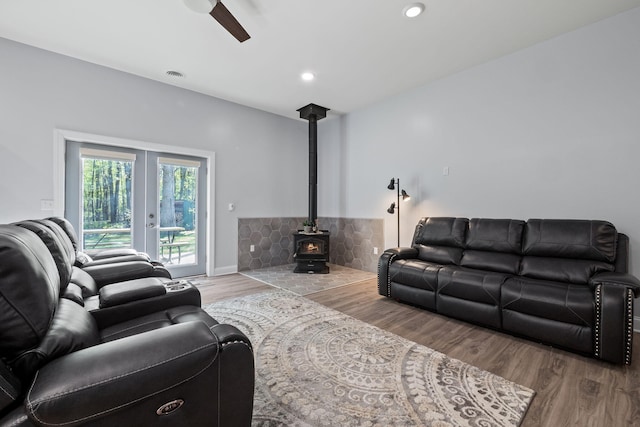 4624 Parman Rd, Stockbridge, MI 49285 - living area featuring wood finished floors, a ceiling fan, a wood stove, recessed lighting, and french doors