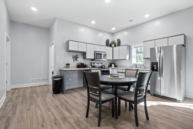 4624 Parman Rd, Stockbridge, MI 49285 - dining room featuring light wood finished floors, baseboards, and recessed lighting
