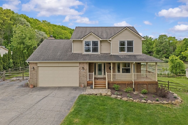 4900 Grass Lake Rd, White Lake, MI 48383 - view of front of home featuring covered porch, brick siding, an attached garage, and asphalt driveway