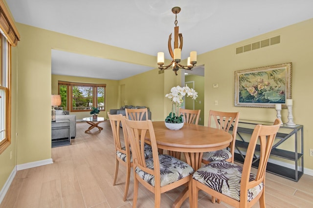 4900 Grass Lake Rd, White Lake, MI 48383 - dining space with a chandelier, baseboards, and light wood finished floors