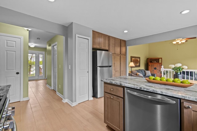 4900 Grass Lake Rd, White Lake, MI 48383 - kitchen with stainless steel appliances, light wood-type flooring, open floor plan, baseboards, and recessed lighting
