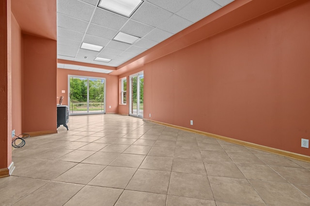 4900 Grass Lake Rd, White Lake, MI 48383 - unfurnished room with a drop ceiling, light tile patterned floors, and baseboards