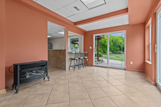 4900 Grass Lake Rd, White Lake, MI 48383 - empty room with a drop ceiling, tile patterned flooring, plenty of natural light, and baseboards