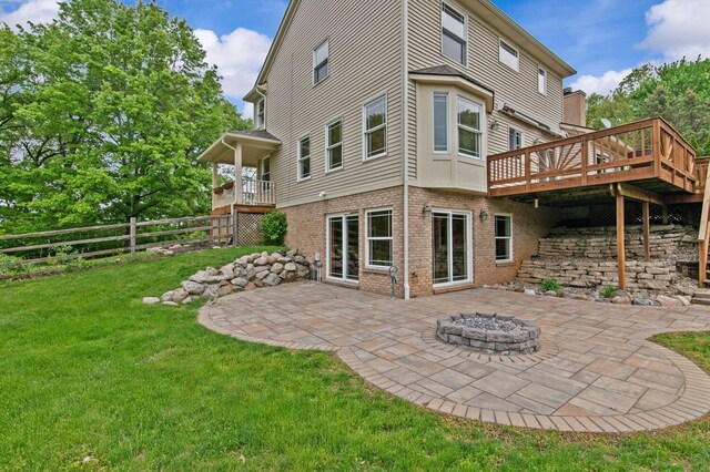 4900 Grass Lake Rd, White Lake, MI 48383 - rear view of property with brick siding, a patio, a wooden deck, and an outdoor fire pit