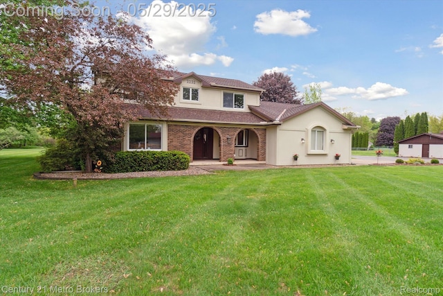 2232 Hayward St, Clio, MI 48420 - view of front of house featuring a front lawn, stucco siding, and a porch