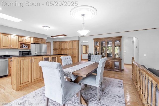 2232 Hayward St, Clio, MI 48420 - dining space featuring arched walkways and light wood-style flooring