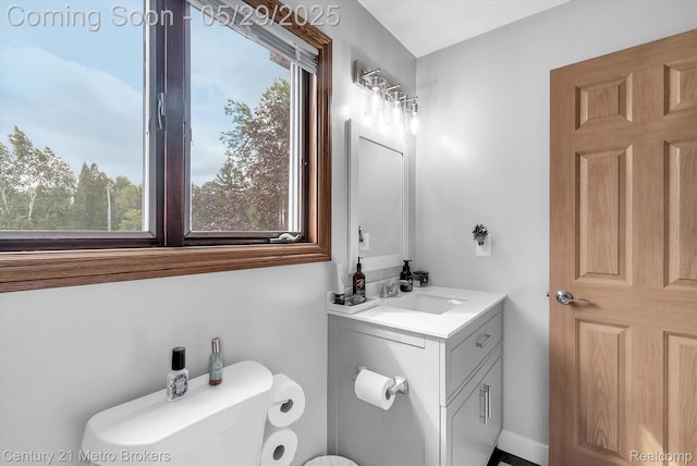 2232 Hayward St, Clio, MI 48420 - bathroom featuring toilet, vanity, and plenty of natural light