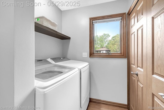 2232 Hayward St, Clio, MI 48420 - laundry area with washing machine and dryer, light wood-style flooring, and baseboards