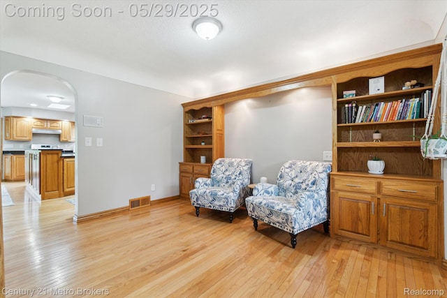 2232 Hayward St, Clio, MI 48420 - sitting room featuring light wood-style floors, arched walkways, and baseboards