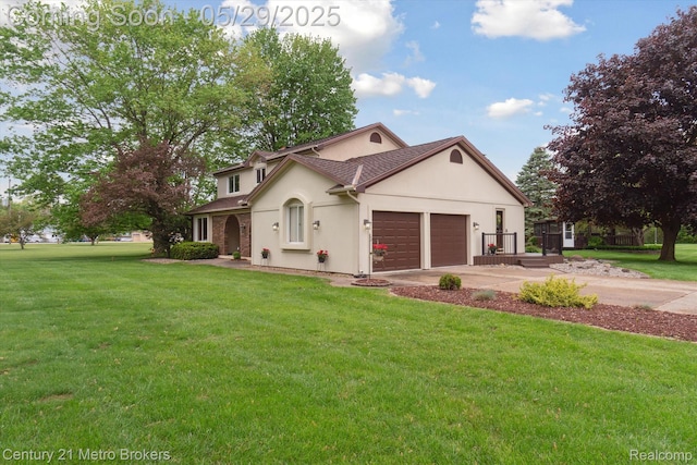 2232 Hayward St, Clio, MI 48420 - view of front of home featuring stucco siding, an attached garage, a front lawn, and driveway