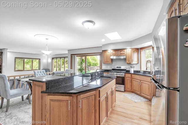 2232 Hayward St, Clio, MI 48420 - kitchen featuring appliances with stainless steel finishes, a sink, under cabinet range hood, and a center island with sink